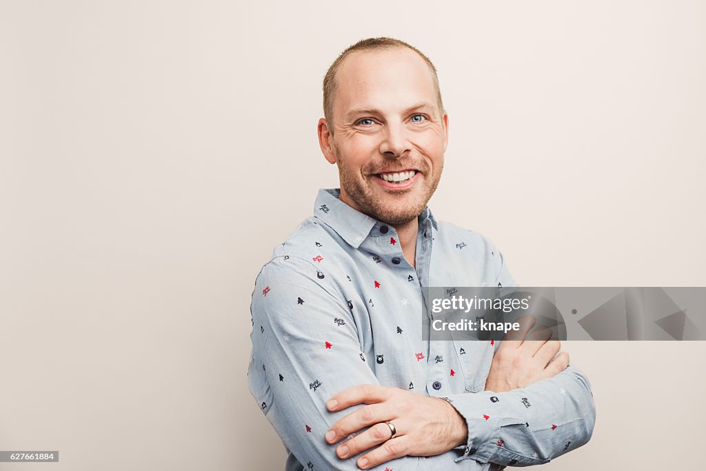 Guapo hombre real con camisa de Navidad sonriendo