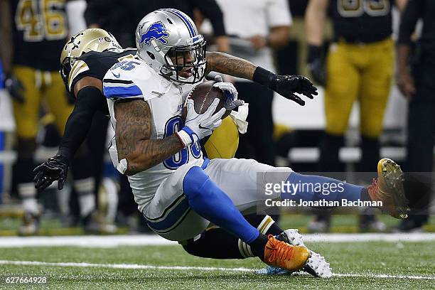 Eric Ebron of the Detroit Lions catches the ball as Vonn Bell of the New Orleans Saints defends during the first half of a game at the Mercedes-Benz...