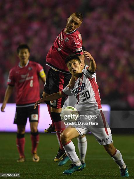 Souza of Cerezo Osaka and Yuta Toyokawa#30 of Fagiano Okayama compete for the ball during the J.League J1 Promotion Play-Off final between Cerezo...