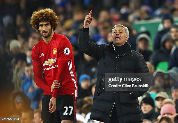 Jose Mourinho manager of Manchester United stands alongside substitute Marouane Fellaini of Manchester United during the Premier League match between...