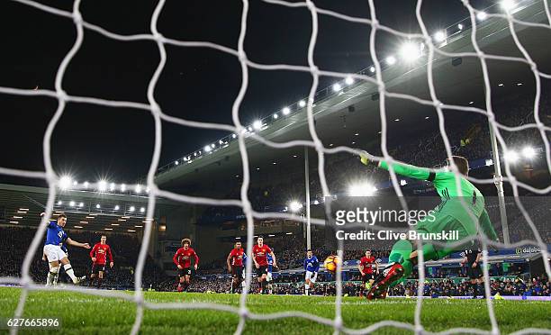 Leighton Baines of Everton scores their first and equalising goal from the penalty spot past goalkeeper David De Gea of Manchester United during the...