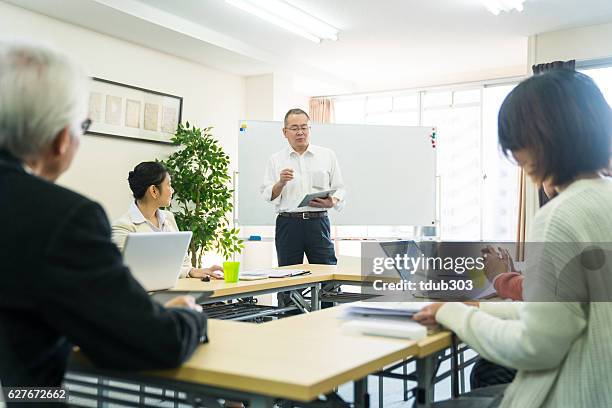 teacher with adult students in community college - japan training session stock pictures, royalty-free photos & images