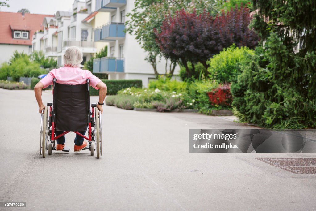 Senior man in wheelchair, enjoying a day in the city