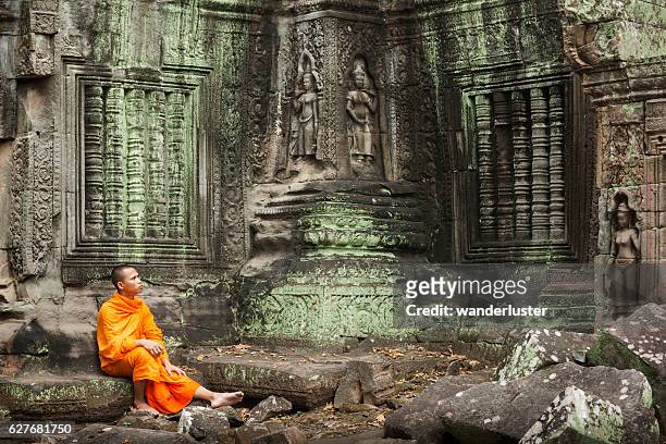 contemplative monk at ruins - siem reap stock pictures, royalty-free photos & images