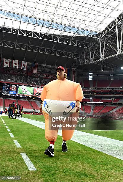 Zac Dysert of the Arizona Cardinals walks back to the locker room after having the stretch in an inflatable baby costume prior to a game against the...