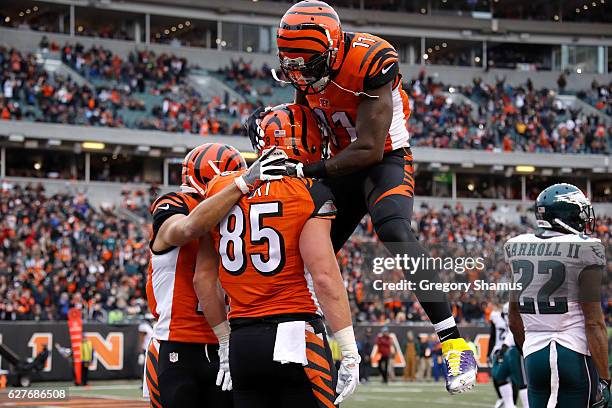 Tyler Eifert is congratulated by Alex Erickson and Brandon LaFell, all of the Cincinnati Bengals, after scoring a touchdown during the second quarter...