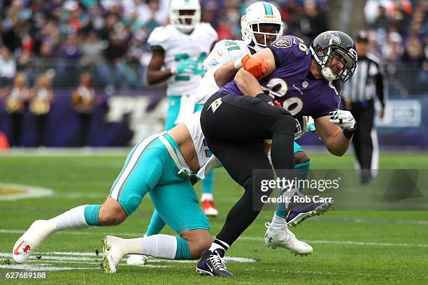 Tight end Dennis Pitta of the Baltimore Ravens is tackled by middle linebacker Kiko Alonso of the Miami Dolphins in the first quarter at M&T Bank...