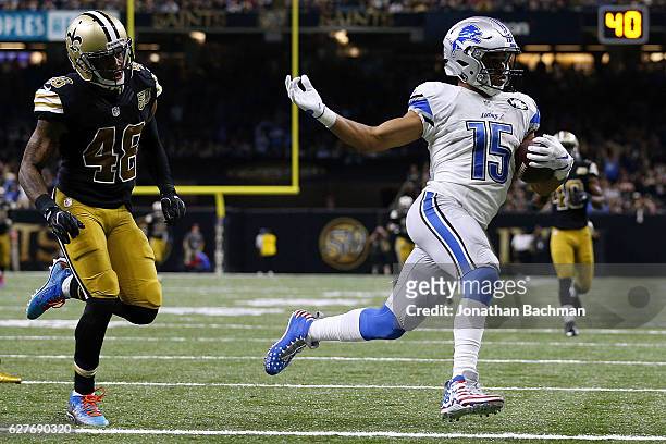 Golden Tate of the Detroit Lions scores a touchdown as Vonn Bell of the New Orleans Saints defends during the second half of a game at the...
