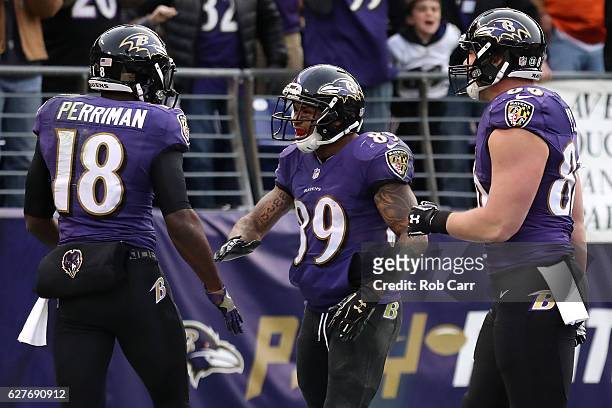 Wide receiver Breshad Perriman of the Baltimore Ravens celebrates with teammates wide receiver Steve Smith and tight end Nick Boyle after scoring a...
