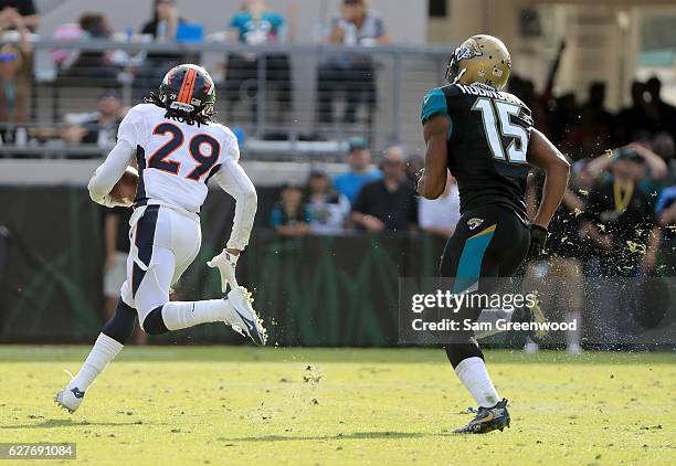 Bradley Roby of the Denver Broncos runs toward the end zone after intercepting a pass intended for Allen Robinson of the Jacksonville Jaguars at...
