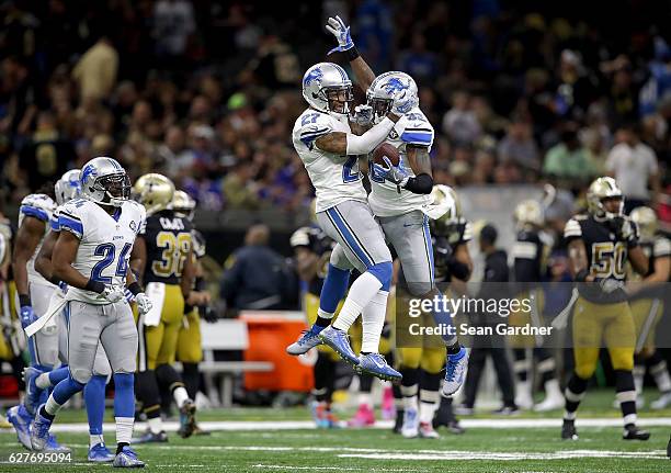 Glover Quin of the Detroit Lions celebrates with Tavon Wilson of the Detroit Lions after Wilson intercepted a pass in the fourth quarter against the...