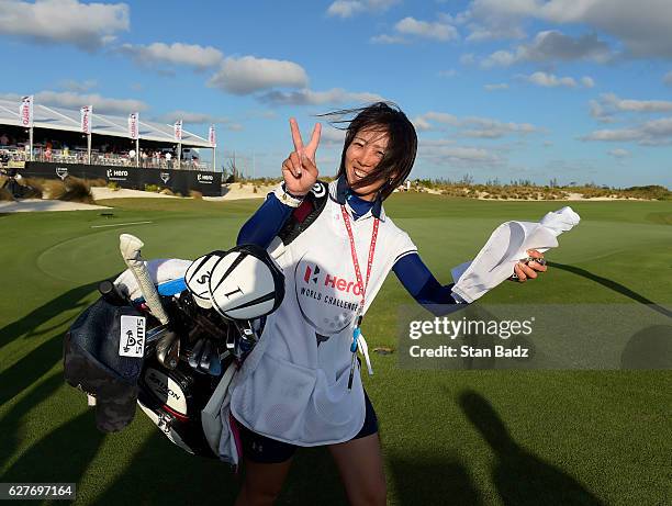 Mei Inui who caddied for Hideki Matsuyama of Japan flashes a victory sign after the final round of the Hero World Challenge at Albany course on...