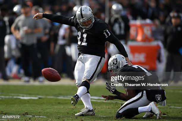 Sebastian Janikowski of the Oakland Raiders kicks a field goal against the Buffalo Bills during their NFL game at Oakland Alameda Coliseum on...