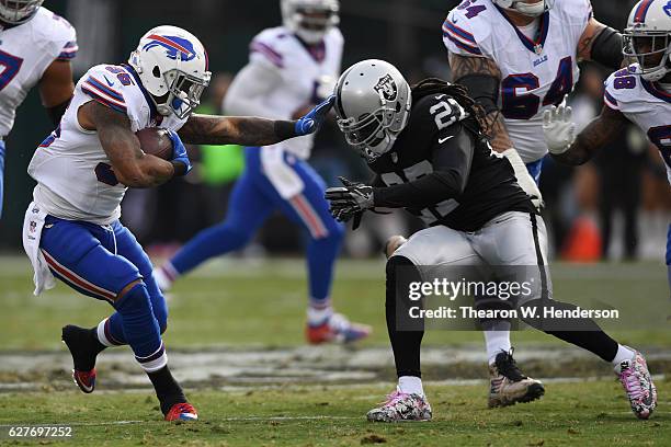 Mike Gillislee of the Buffalo Bills rushes with the ball against Reggie Nelson of the Oakland Raiders during their NFL game at Oakland Alameda...
