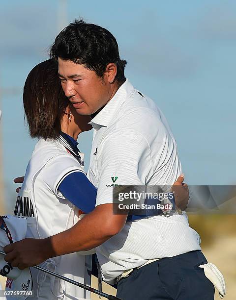 Caddie Mei Inui hugs Hideki Matsuyama of Japan on the 18th hole after they won the Hero World Challenge at Albany course on December 4, 2016 in...