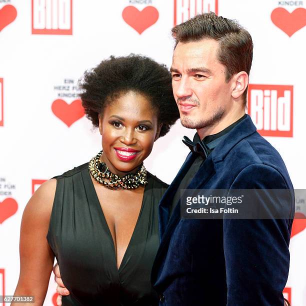 Dancer Motsi Mabuse and friend attend the Ein Herz Fuer Kinder gala on December 3, 2016 in Berlin, Germany.