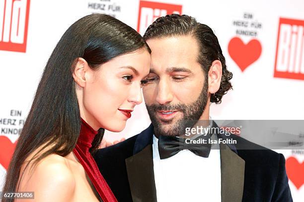 Model Rebecca Mir and her husband dancer Massimo Senato attend the Ein Herz Fuer Kinder gala on December 3, 2016 in Berlin, Germany.