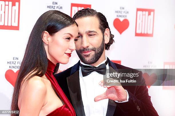 Model Rebecca Mir and her husband dancer Massimo Senato attend the Ein Herz Fuer Kinder gala on December 3, 2016 in Berlin, Germany.