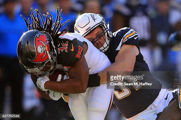 Kyle Emanuel of the San Diego Chargers brings down Jacquizz Rodgers of the Tampa Bay Buccaneers during the first half of a game at Qualcomm Stadium...