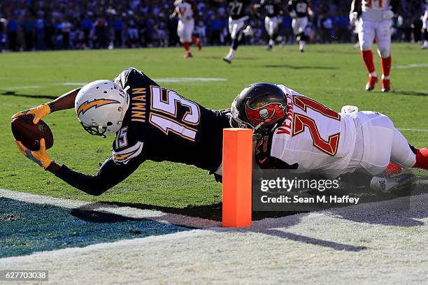 With Alterraun Verner of the Tampa Bay Buccaneers defending, Dontrelle Inman of the San Diego Chargers gets the ball over the goal line to score...