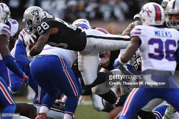 Latavius Murray of the Oakland Raiders dives into the endzone for a touchdown against the Buffalo Bills during their NFL game at Oakland Alameda...