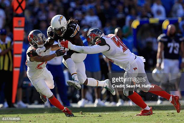 Brent Grimes and Kwon Alexander of the Tampa Bay Buccaneers tackle Melvin Gordon of the San Diego Chargers on a run play during the first half of a...