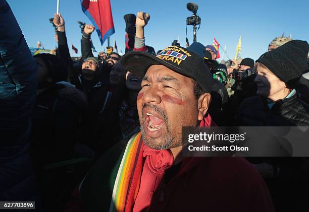 Native American and other activists celebrate after learning an easement had been denied for the Dakota Access Pipeline at Oceti Sakowin Camp on the...