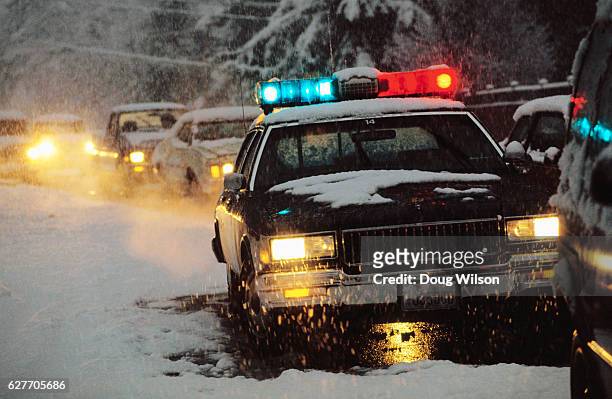 police car at winter accident scene - cop car photos et images de collection