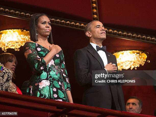 President Barack Obama and First Lady Michelle Obama stand for the National Anthem during the 2016 Kennedy Center Honors at the Kennedy Center on...