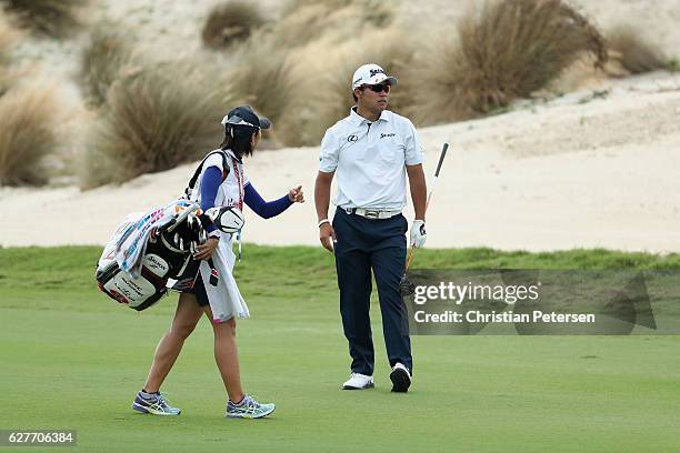 Hideki Matsuyama of Japan talks with caddie Mei Inui on the third hole during the final round of the Hero World Challenge at Albany, The Bahamas on...