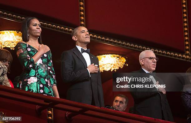 President Barack Obama and First Lady Michelle Obama stand for the National Anthem during the 2016 Kennedy Center Honors at the Kennedy Center on...