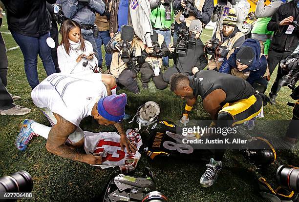 Antonio Brown of the Pittsburgh Steelers and Odell Beckham of the New York Giants autograph jerseys for each other at the conclusion of the...