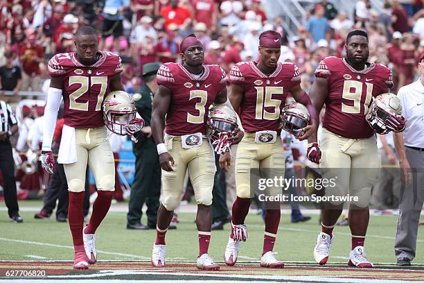 Florida State captains DB Marquez White , WR Jesus ìBoboî Wilson , WR Travis Rudolph , and DT Derrick Nnadi go to midfield for the coin toss before...