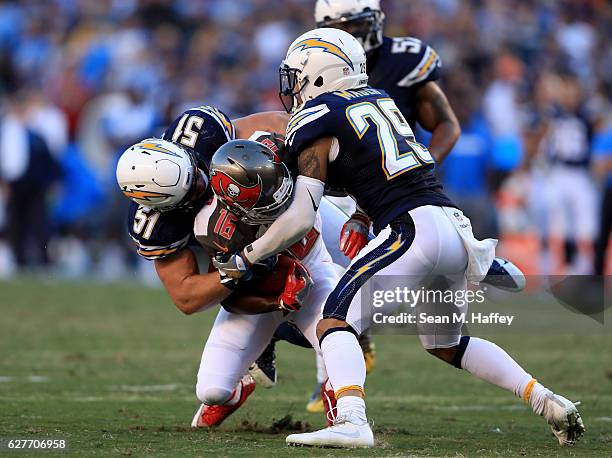 Kyle Emanuel and Craig Mager of the San Diego Chargers bottle up Freddie Martino of the Tampa Bay Buccaneers during the second half of a game at...