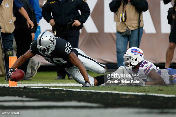 Amari Cooper of the Oakland Raiders dives into the end zone for a touchdown against the Buffalo Bills during their NFL game at Oakland Alameda...