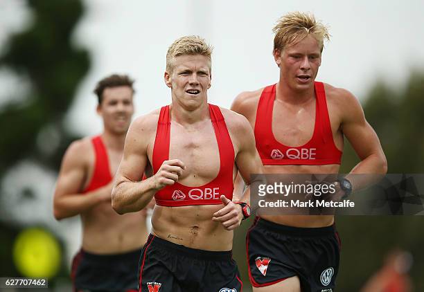 Daniel Hannebery and Isaac Heeney run during a Sydney Swans AFL pre-season training session at Lakeside Oval on December 5, 2016 in Sydney, Australia.