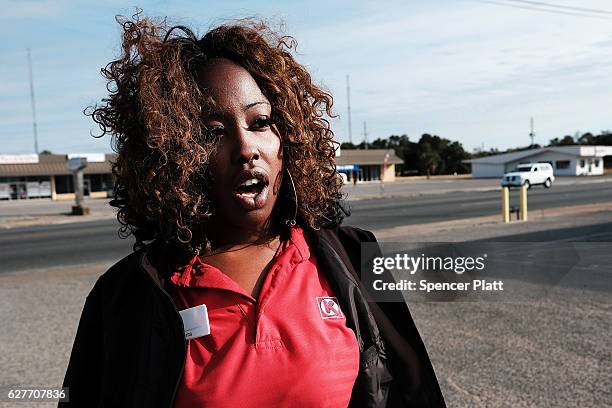 Tierra Mullins, who works as a low wage cashier, pauses in a struggling neighborhood in Pensacola on December 3, 2016 in Pensacola, Florida....