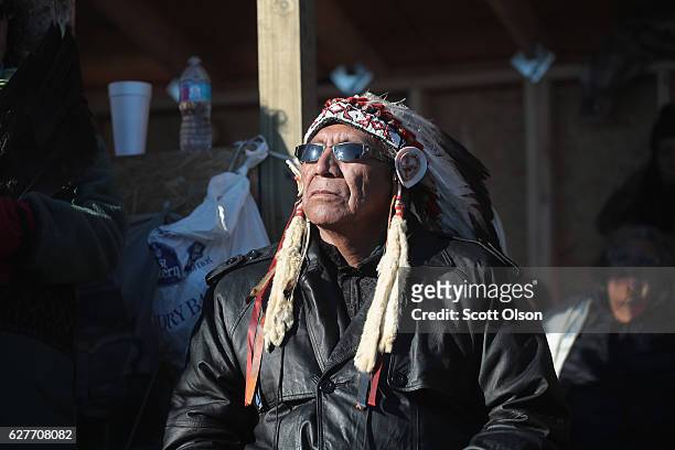 Chief Arvol Looking Horse of the Lakota/Dakota/Nakota Nation listens to speakers during an interfaith ceremony at Oceti Sakowin Camp on the edge of...