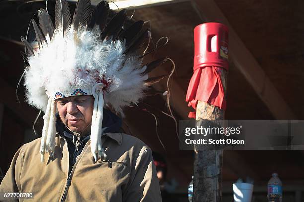 Lance King of the Ogalala Lakota listens to speakers during an interfaith ceremony at Oceti Sakowin Camp on the edge of the Standing Rock Sioux...