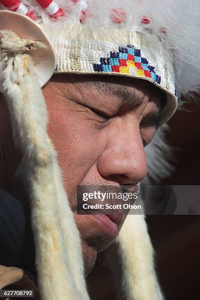 Lance King of the Ogalala Lakota listens to speakers during an interfaith ceremony at Oceti Sakowin Camp on the edge of the Standing Rock Sioux...