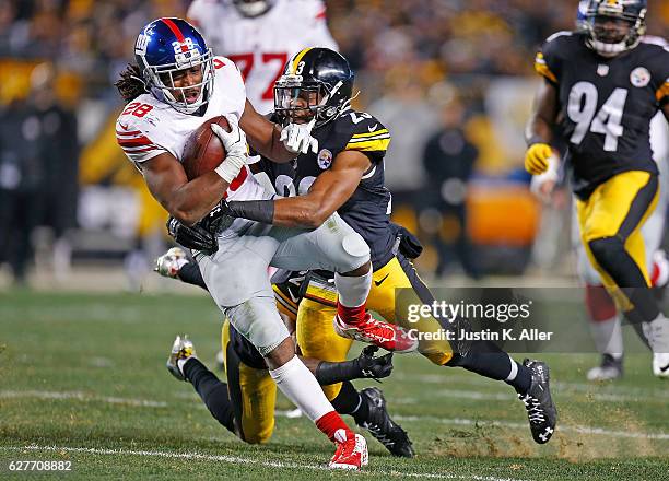 Paul Perkins of the New York Giants is tackled by Mike Mitchell of the Pittsburgh Steelers in the second half during the game at Heinz Field on...