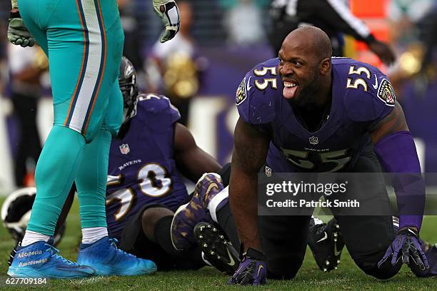 Outside linebacker Terrell Suggs of the Baltimore Ravens reacts after hitting quarterback Ryan Tannehill of the Miami Dolphins in the third quarter...