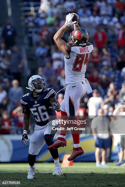 Cameron Brate of the Tampa Bay Buccaneers catches a pass over Korey Toomer of the San Diego Chargers in the second quarter at Qualcomm Stadium on...