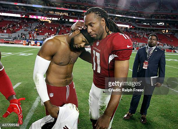 Larry Fitzgerald of the Arizona Cardinals embraces Josh Norman of the Washington Redskins following a game at University of Phoenix Stadium on...