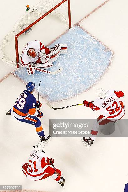 Petr Mrazek of the Detroit Red Wings makes a save against Brock Nelson of the New York Islanders at the Barclays Center on December 4, 2016 in...