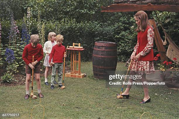 Paola Ruffo di Calabria, later Queen Paola of Belgium, pictured playing croquet with her children, from left, Prince Philippe , Princess Astrid and...