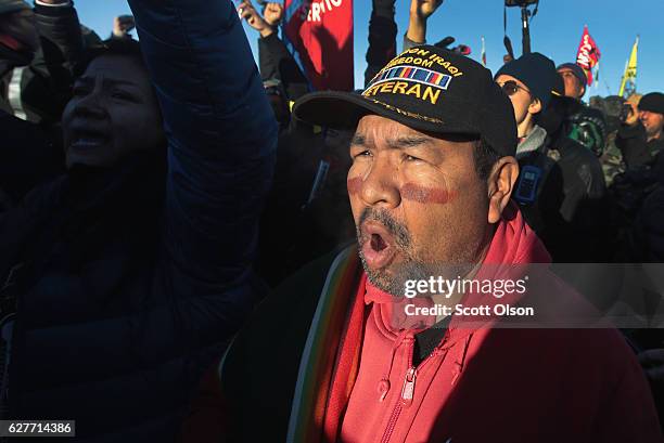 Native American activists celebrate after learning an easement had been denied for the Dakota Access Pipeline at Oceti Sakowin Camp on the edge of...