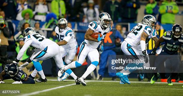 Running back Fozzy Whittaker of the Carolina Panthers rushes against the Seattle Seahawks at CenturyLink Field on December 4, 2016 in Seattle,...
