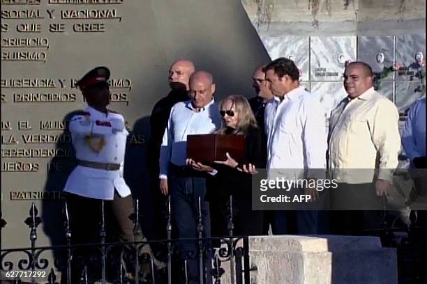 This grab from CubanTV shows the family of late Cuban leader Fidel Castro, , Alex Castro, Alexis Castro, Alejandro Castro, his widow Dalia Soto del...