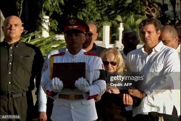 This grab from CubanTV shows the family of late Cuban leader Fidel Castro, , Alex Castro, Alexis Castro, Alejandro Castro, his widow Dalia Soto del...